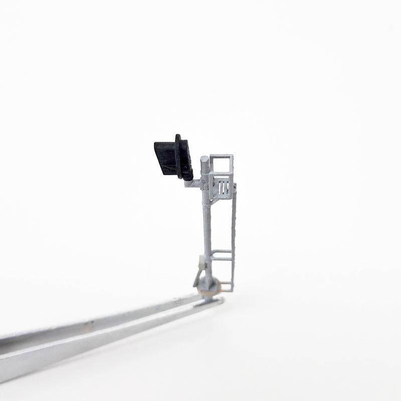 Top view of a silver model train mast signal.