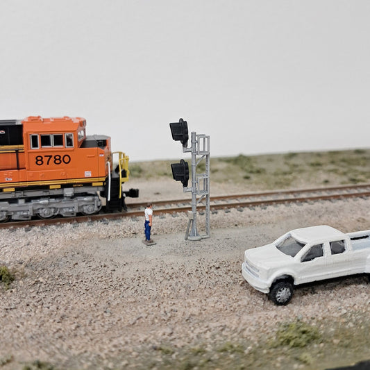 A BNSF diesel locomotive stopped at a double head signal model.