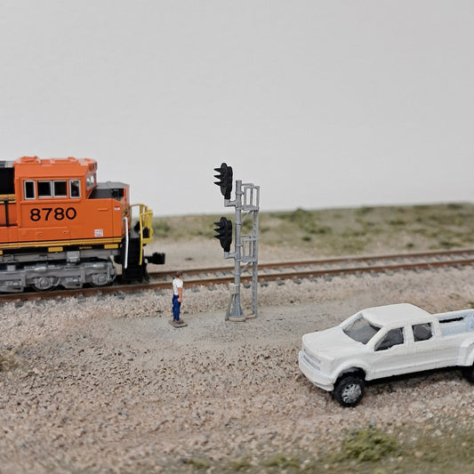 Diesel locomotive in N scale stopped at a double head signal.