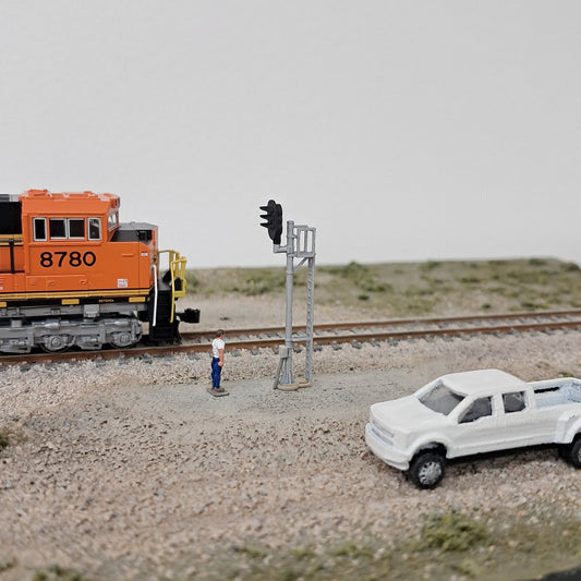 Model railroad signal maintainer looking at a signal.