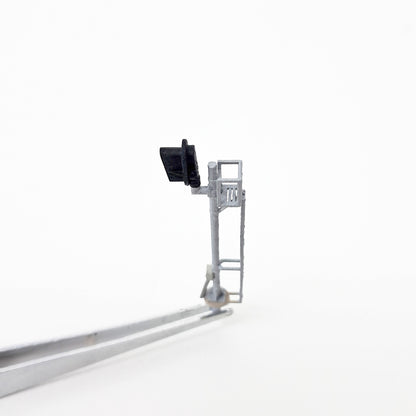 Top view of a silver model train mast signal.