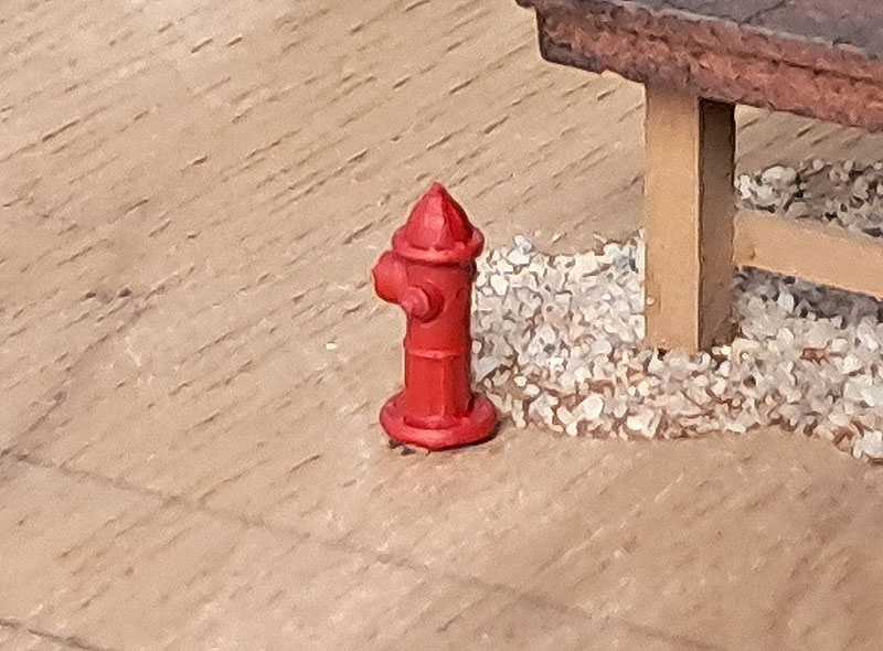 3D printed HO scale fire hydrant painted red.
